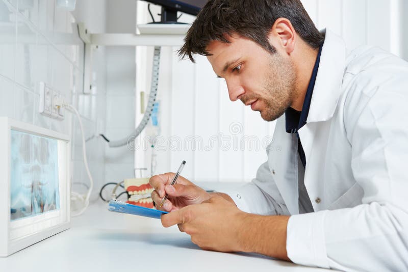 Dentist with Xray Image Taking Notes Stock Photo Image of notes