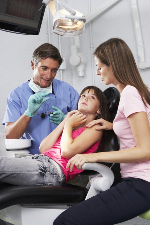 Dentist Reassuring Frightened Girl Before Check Up