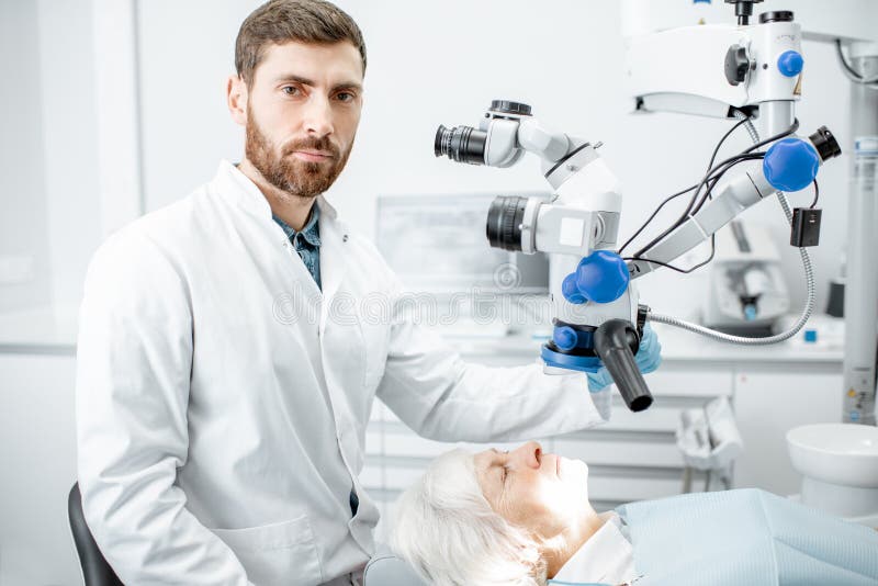 Dentist`s portrait with a microscope stock images Dentist`s portrait with a microscope stock images