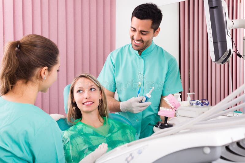 Dentist at surgery office stock photo. Image of assistant 56247252