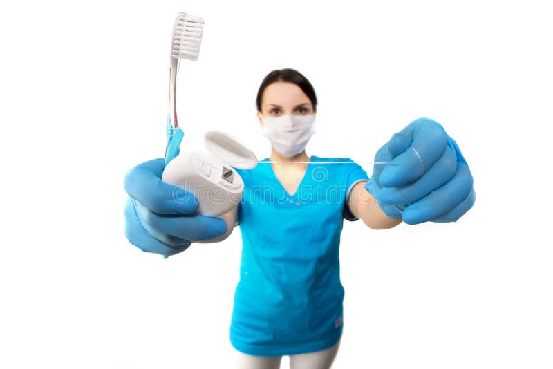 Dentist with tools. Concept of dentistry, whitening, oral hygiene, teeth cleaning with toothbrush, floss. Dentistry, taking care of a beautiful and healthy smile. Dental tooth care clinic. Stomatology