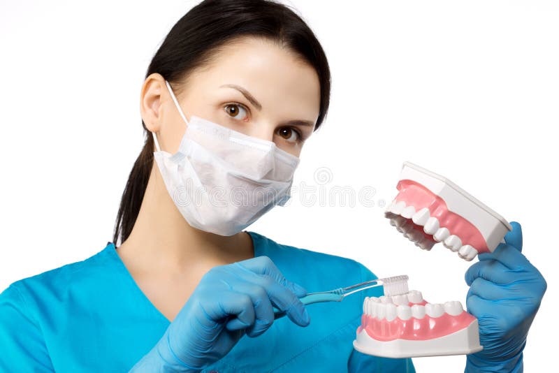 Dentist with tools. Dentist. The concept of dentistry, whitening, oral hygiene, teeth cleaning with toothbrush and floss. Dentistry, taking care of a beautiful and healthy smile. Dental tooth care clinic. Stomatology