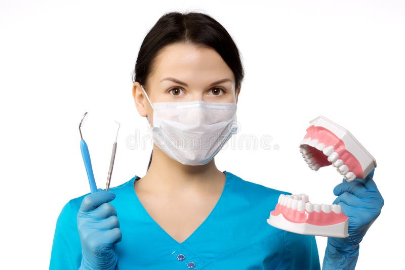 Dentist with tools. Dentist. The concept of dentistry, whitening, oral hygiene, teeth cleaning with toothbrush and floss. Dentistry, taking care of a beautiful and healthy smile. Dental tooth care clinic. Stomatology