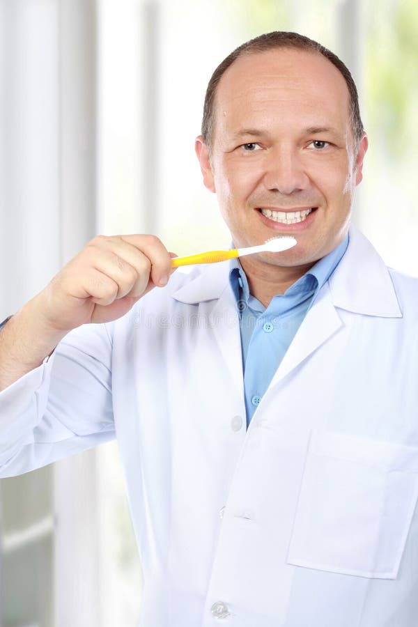 Dentist with toothbrush
