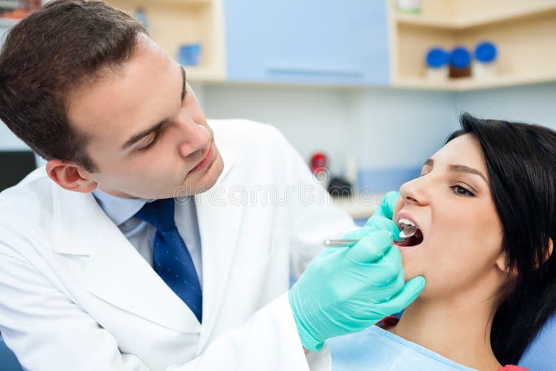 Dentist Is Treating Teeth Of The Patient Royalty Free Stock Photos