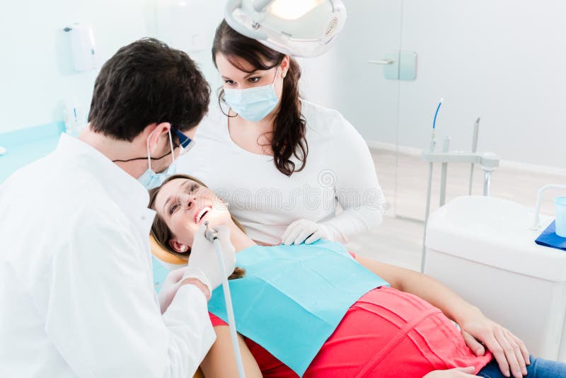 Dentist Treating Woman Patient with Drill Stock Photo Image of room