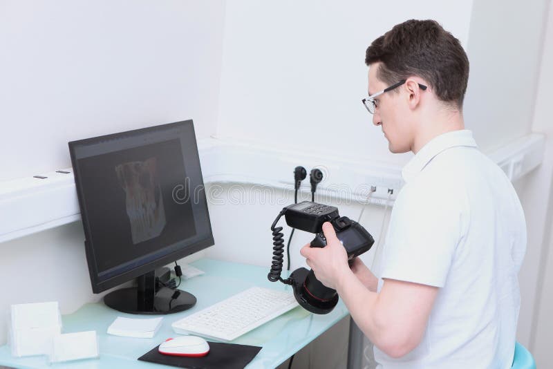 The Dentist Views the 3D Image of the Teeth on the Computer. a Camera