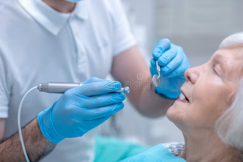 Dentist in Sterile Gloves Working with a Patient in His Office Stock Image Image of patient