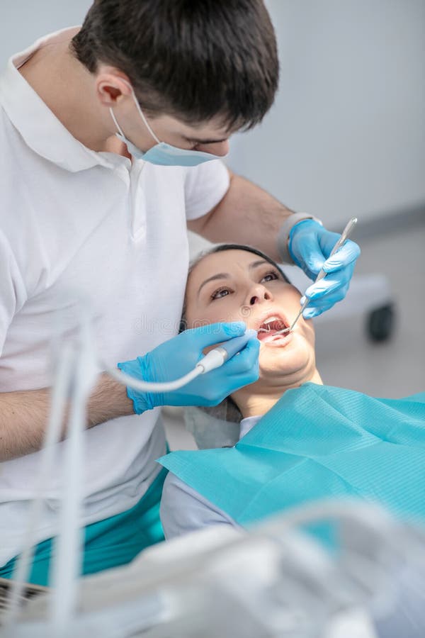Dentist Working on Patients Teeth Restoration and Making Dental