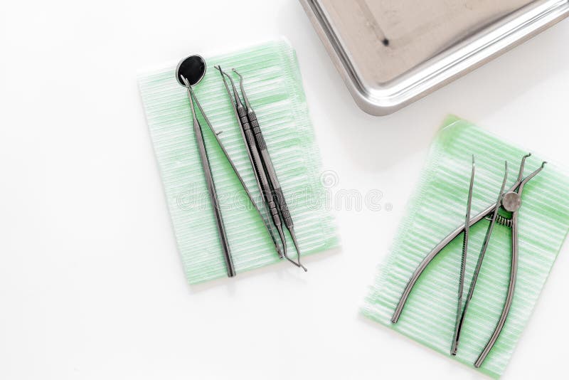 Dentists Accessories. Tools on White Background Top View Copyspace