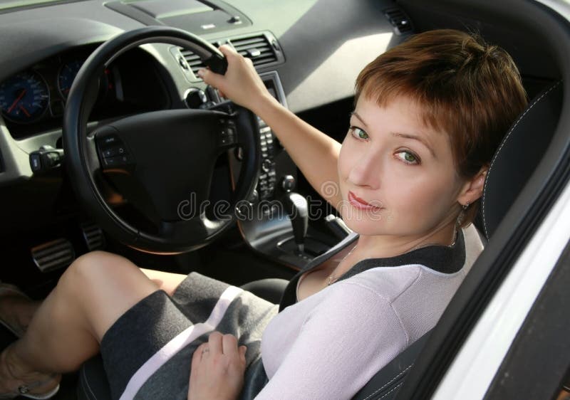 Inside interior of sport auto with driving beautiful woman looking in camera. Inside interior of sport auto with driving beautiful woman looking in camera