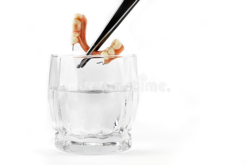 Denture wydobuje z pincetami obrazy stock Denture wydobuje z pincetami obrazy stock