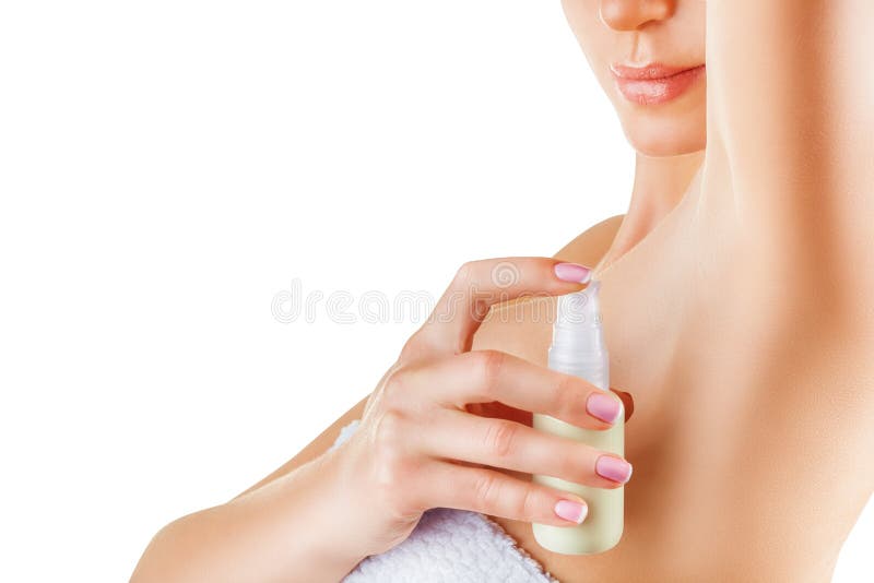 Close up of woman applying deodorant on underarm isolated on a white background