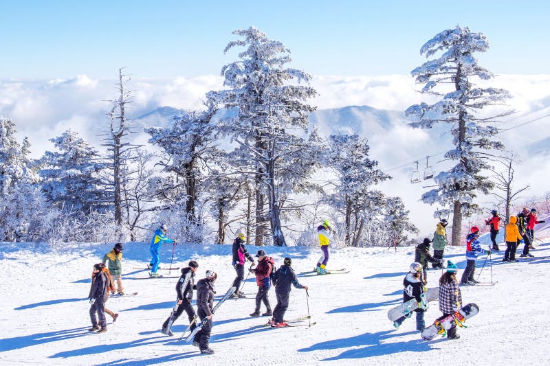 DEOGYUSAN,KOREA - JANUARY 23: Tourists taking photos of the beautiful scenery and skiing around Deogyusan,South Korea on January 23, 2015. DEOGYUSAN,KOREA - JANUARY 23: Tourists taking photos of the beautiful scenery and skiing around Deogyusan,South Korea on January 23, 2015.