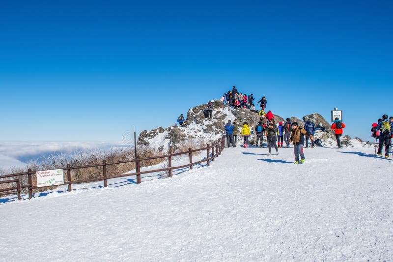 DEOGYUSAN,KOREA - JANUARY 23: Tourists taking photos of the beautiful scenery and skiing around Deogyusan,South Korea on January 23, 2015. DEOGYUSAN,KOREA - JANUARY 23: Tourists taking photos of the beautiful scenery and skiing around Deogyusan,South Korea on January 23, 2015.