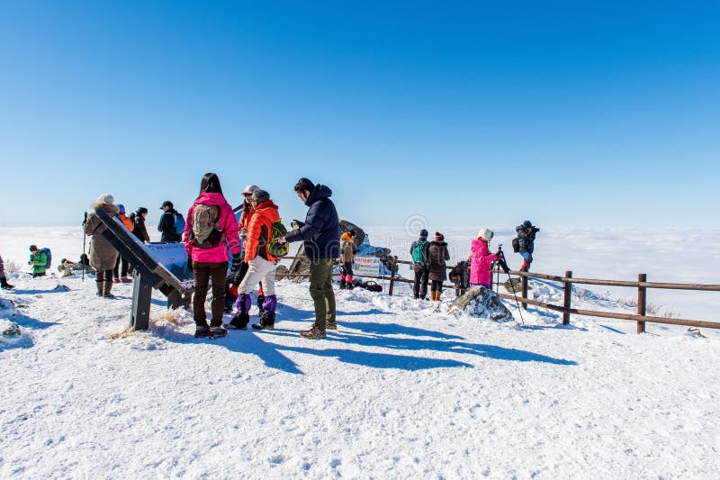 DEOGYUSAN,KOREA - JANUARY 23: Tourists taking photos of the beautiful scenery and skiing around Deogyusan,South Korea on January 23, 2015. DEOGYUSAN,KOREA - JANUARY 23: Tourists taking photos of the beautiful scenery and skiing around Deogyusan,South Korea on January 23, 2015.