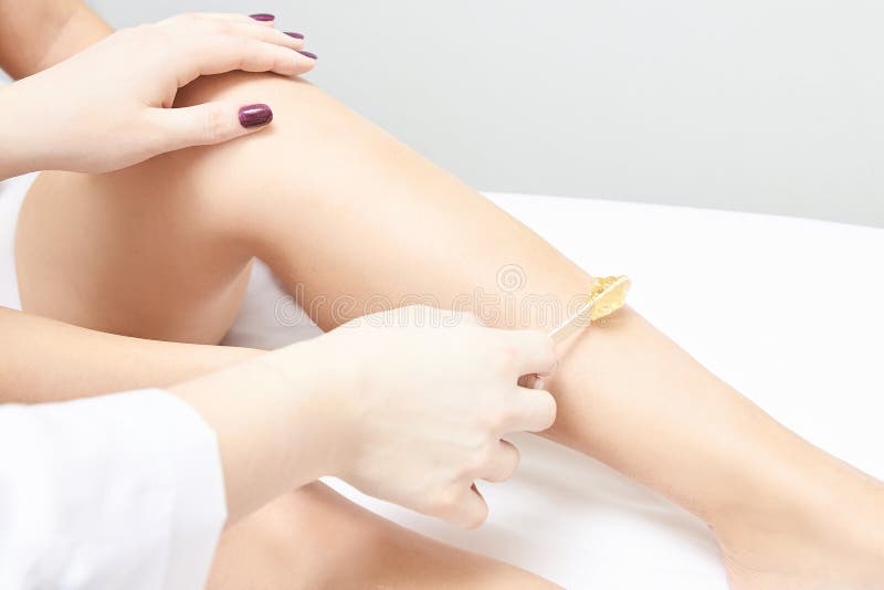 Depilation spa procedure. Woman hair remove waxing. Epilation sugaring. Legs foot. profi help royalty free stock image Depilation spa procedure. Woman hair remove waxing. Epilation sugaring. Legs foot. profi help royalty free stock image