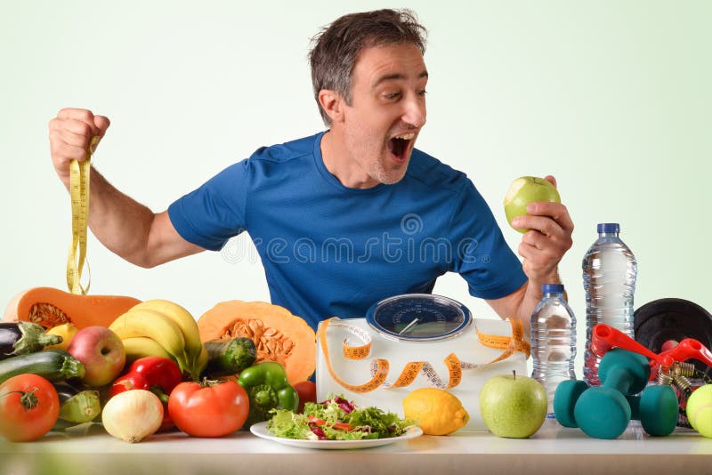 Deportista comiendo manzanas divertidas mostrando frutas y verduras y escala imagen de archivo