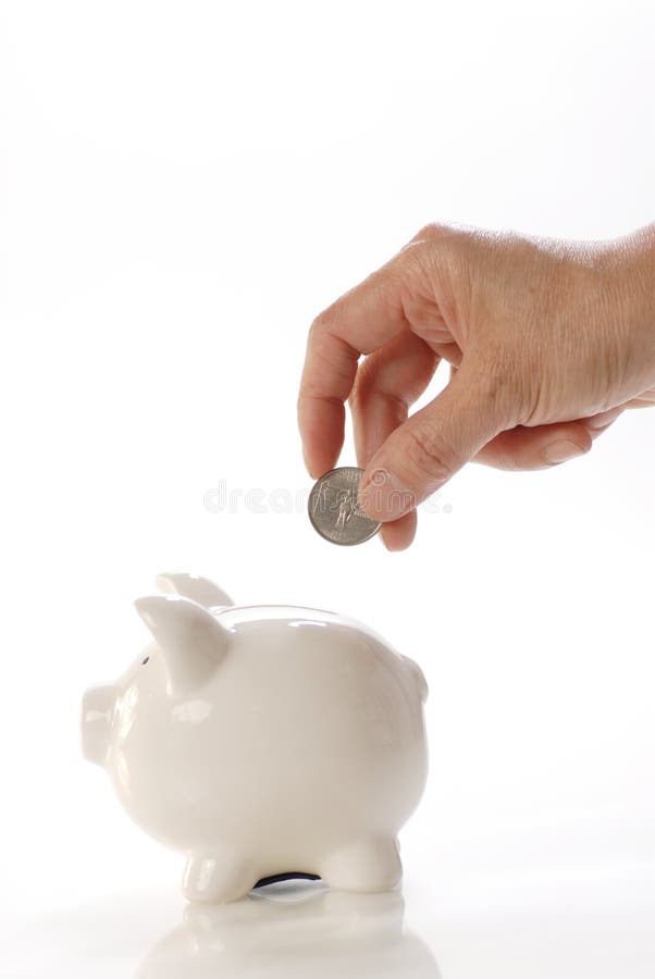 Deposits coin in piggy bank