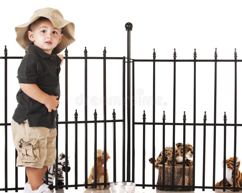 An adorable preschooler playing zookeeper with his toy animals. An adorable preschooler playing zookeeper with his toy animals.