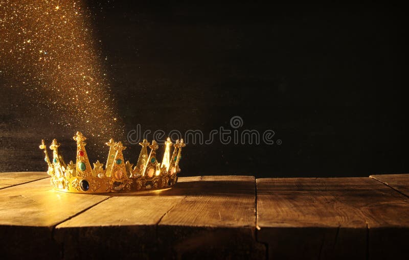 low key image of beautiful queen/king crown over wooden table. vintage filtered. fantasy medieval period. low key image of beautiful queen/king crown over wooden table. vintage filtered. fantasy medieval period