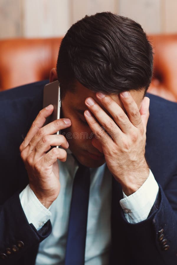 Depressed businessman talking on phone