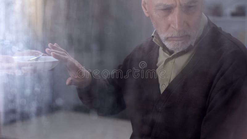 Depressed male pensioner refusing to eat porridge, feeling lonely in hospice stock photos Depressed male pensioner refusing to eat porridge, feeling lonely in hospice stock photos