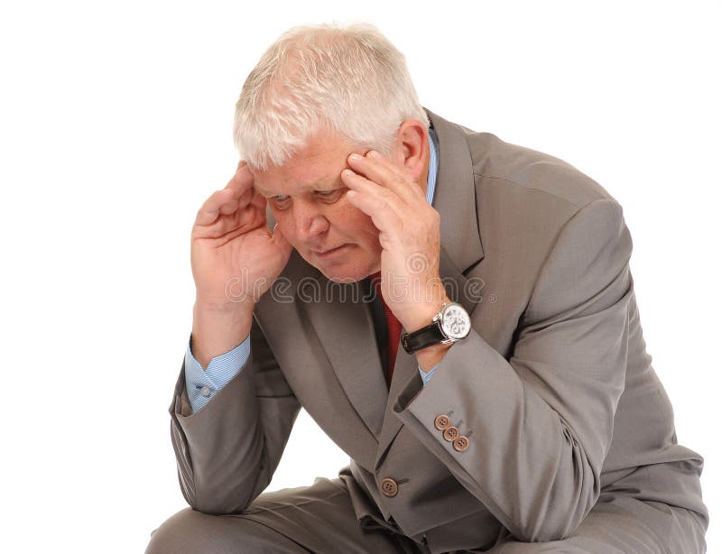 Depressed mature businessman holding head