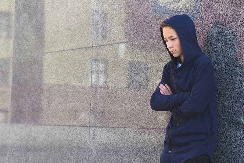 Depressed sad teenage boy on a dark background, teenage problem concept royalty free stock photography Depressed sad teenage boy on a dark background, teenage problem concept royalty free stock photography