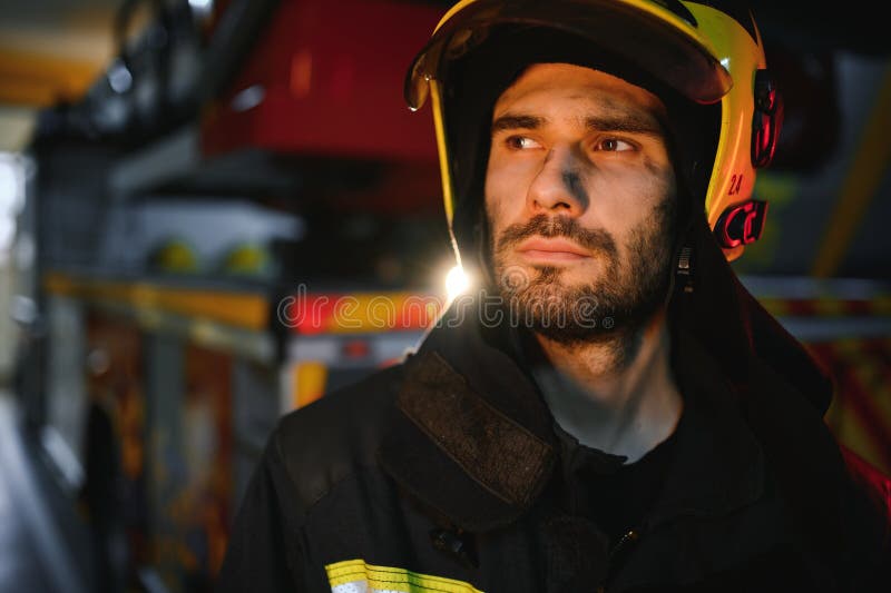 Depressed and tired firefighter near fire truck royalty free stock images