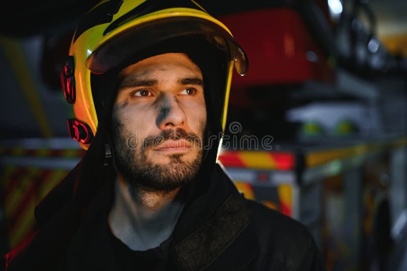 Depressed and tired firefighter near fire truck royalty free stock image