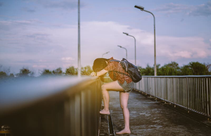 Depressed Young Asian Woman Standing on a Bridge,Nagative Attitude ...