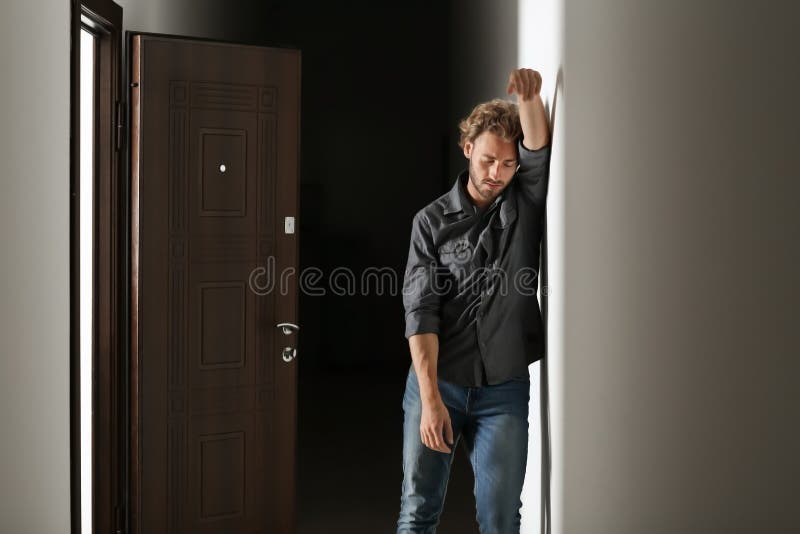 Depressed young man in dark corridor royalty free stock photo Depressed young man in dark corridor royalty free stock photo