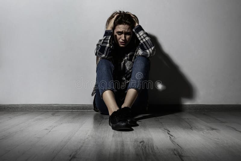 Depressed Young Woman Sitting Alone Near Wall. Autophobia - Fear of ...