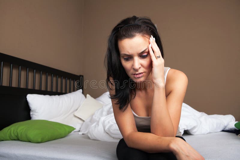 Depressed young woman sitting stock image