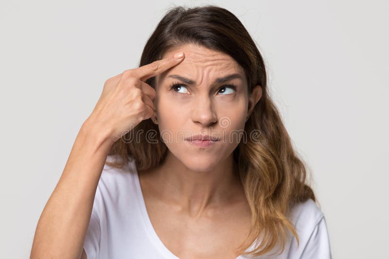 Dissatisfied stressed depressed young woman touch forehead worried about skin wrinkle isolated on studio background, cosmetology botox injection anti aging cream concept, cosmetology facial treatment. Problem wrinkle stock images, royalty-free photos and pictures