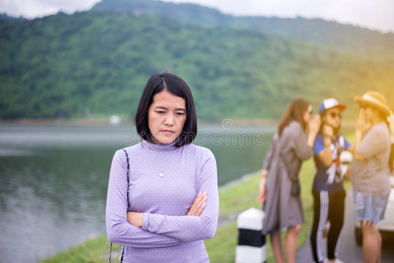 Depression asian woman after being gossiped from her friends