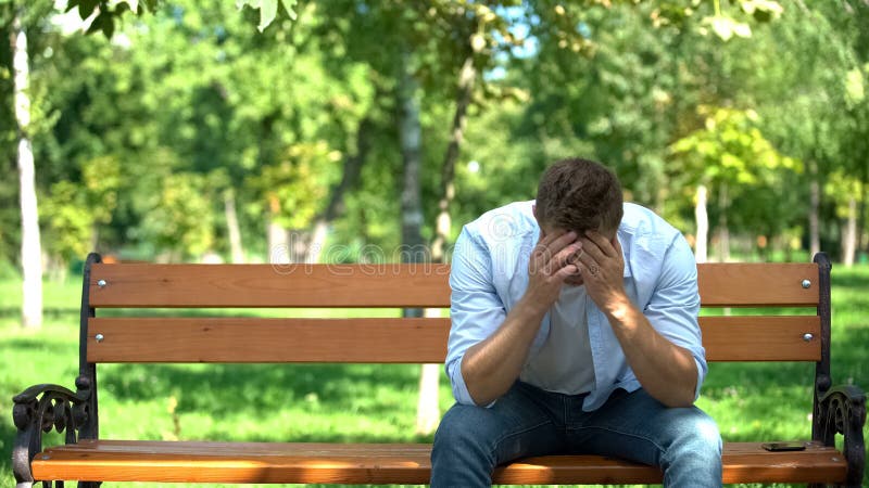 Depressed young man sitting alone bench thinking problem, broken heart, crisis, stock photo. Depressed young man sitting alone bench thinking problem, broken heart, crisis, stock photo