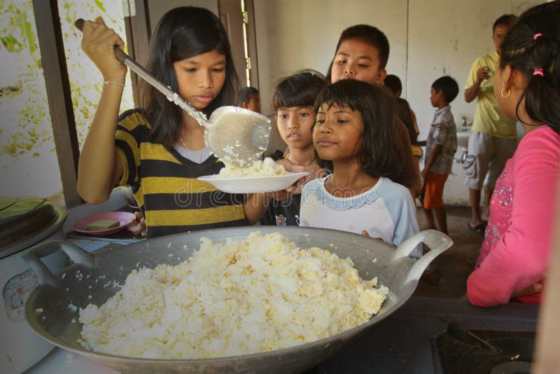 Deprived children get food at lunch time royalty free stock images