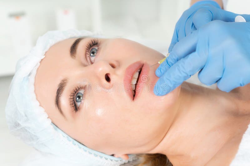 Der Doktor Cosmetologist macht das verjüngende Gesichtseinspritzungsverfahren für augmentationon Lippen von Frauen in einem Schön stockfotografie Der Doktor Cosmetologist macht das verjüngende Gesichtseinspritzungsverfahren für augmentationon Lippen von Frauen in einem Schön stockfotografie