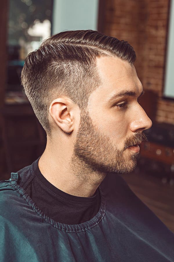 Der junge Mann im Friseursalon stockbild Der junge Mann im Friseursalon stockbild