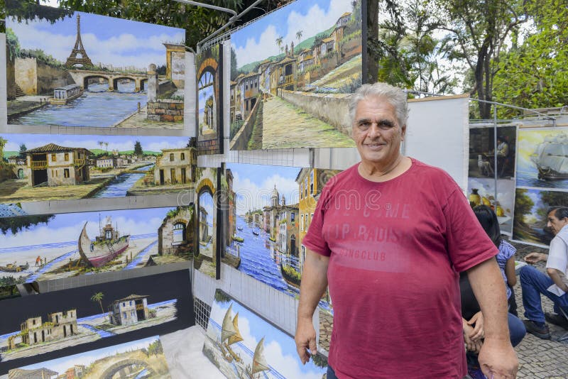 Der kaukasische brasilianische Mann, der Stadtbild verkaufen und die Landschaft ölen die Schmerz stockbilder Der kaukasische brasilianische Mann, der Stadtbild verkaufen und die Landschaft ölen die Schmerz stockbilder