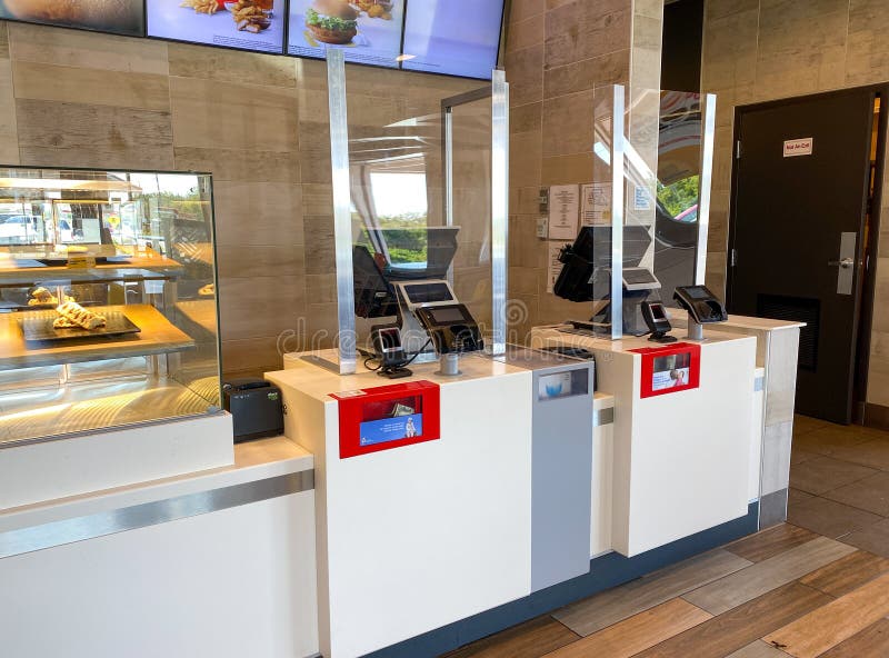 Orlando, FL/USA-9/1/20: The order and payment counter with plexiglass shields for the the coronavirus pandemic at a McDonalds in Orlando, Florida. Orlando, FL/USA-9/1/20: The order and payment counter with plexiglass shields for the the coronavirus pandemic at a McDonalds in Orlando, Florida