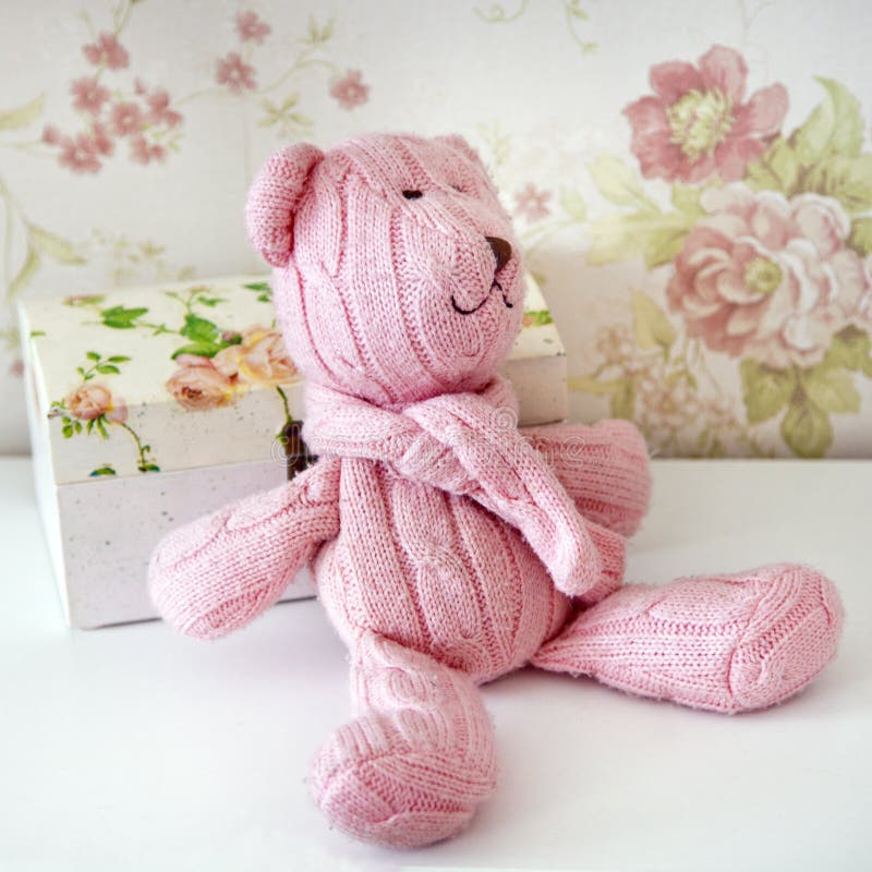 Der rosa gestrickte Teddybär sitzt auf einem Regal stockbild Der rosa gestrickte Teddybär sitzt auf einem Regal stockbild