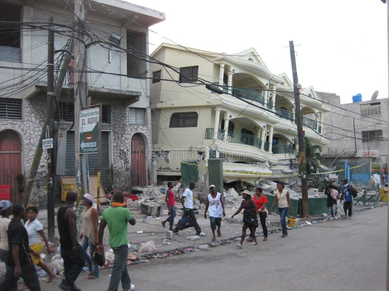 The image portrays the confused people who still wanders the streets of haiti after the earthquake among the buildings destroyed. The image portrays the confused people who still wanders the streets of haiti after the earthquake among the buildings destroyed.