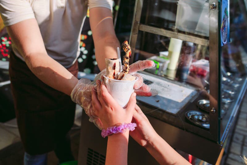 Der Verkäufer führt einem kleinen Mädchen die Eiscreme Angebratene Eiscreme rollt an der Frostwanne Organisches, nat?rliches gero stockbilder Der Verkäufer führt einem kleinen Mädchen die Eiscreme Angebratene Eiscreme rollt an der Frostwanne Organisches, nat?rliches gero stockbilder