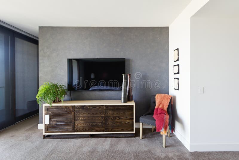 An der Wand befestigtes Fernsehen und Buffet im geräumigen Hauptschlafzimmer lizenzfreie stockbilder An der Wand befestigtes Fernsehen und Buffet im geräumigen Hauptschlafzimmer lizenzfreie stockbilder