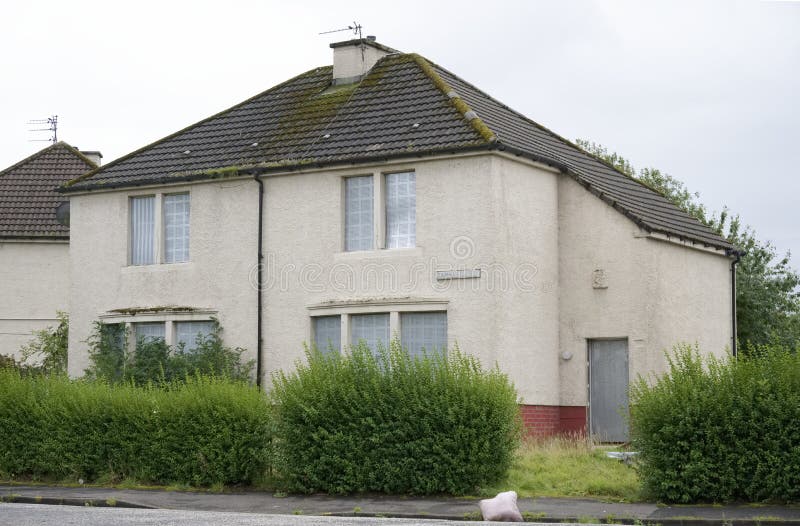 Derelict abandoned council house in poor housing crisis ghetto estate slum Paisley