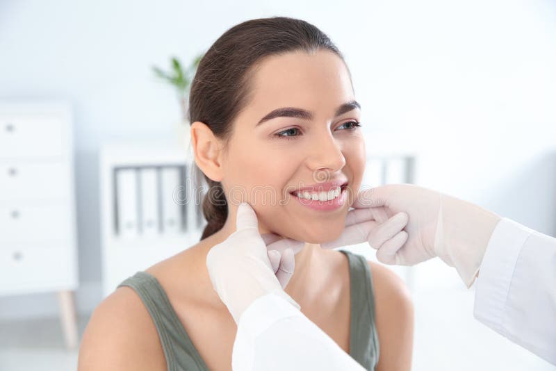 Dermatologist Examining Patient`s Face In Clinic Stock Photo Image