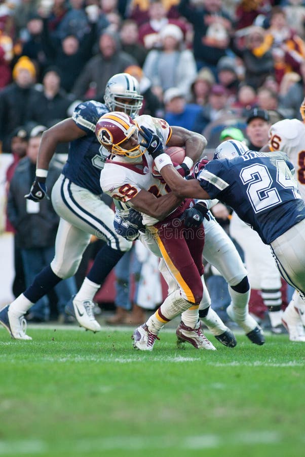 Washington Redskins WR Derrius Thompson 88 is hit by Dallas Cowboys strong safety Tony Dixon 24.  Game was played December 2002 at FedEx Field in Washington, DC. Washington Redskins WR Derrius Thompson 88 is hit by Dallas Cowboys strong safety Tony Dixon 24.  Game was played December 2002 at FedEx Field in Washington, DC.